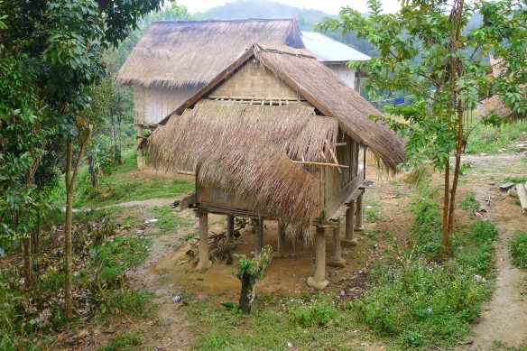 A typical village house in Laos - on stilts due to the possibility of floods or mud slides and for protection from animals, covered with a thatched roof.